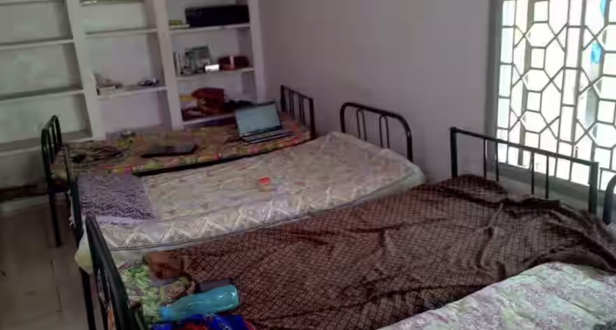 Triple sharing room with three beds and storage